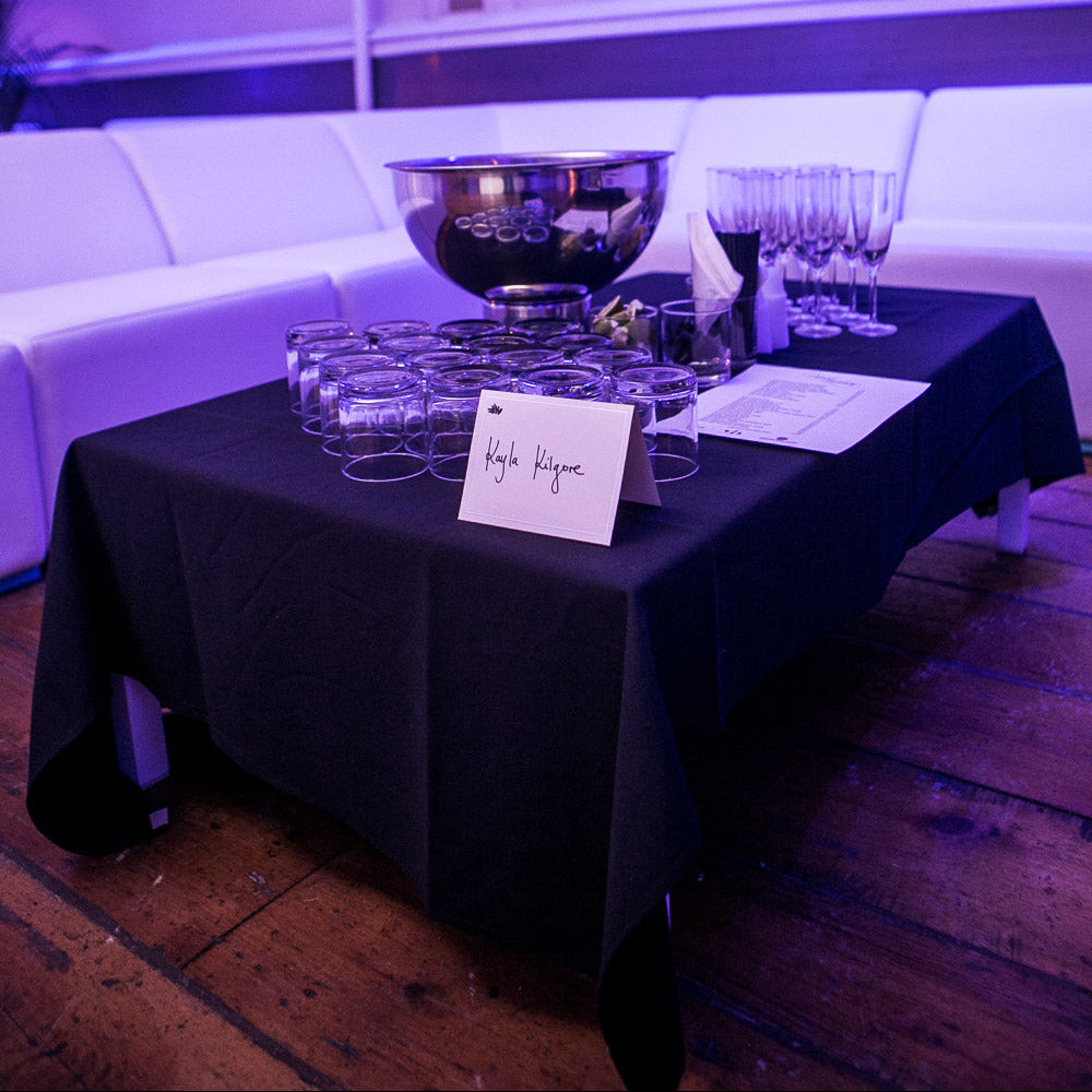 Reserved VIP table with bottle service glasses and name card setup for Final Fantasy New Year’s Eve in Montreal.